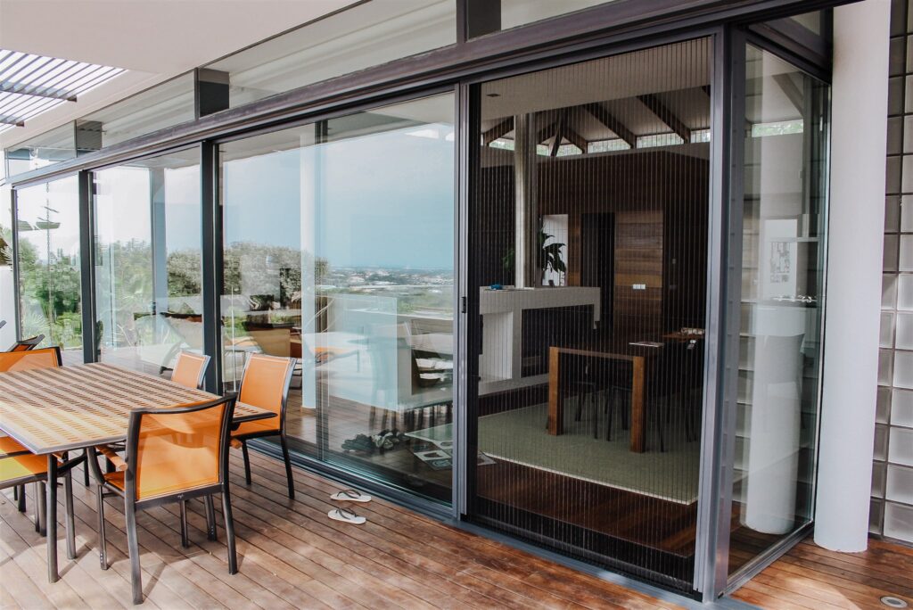 plisse mosquito screens Retractable plisse mosquito screen on tall windows and black frame