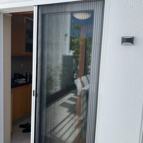 Plisse mosquito screens fitted on a high-traffic area window, showcasing easy accessibility and insect control.