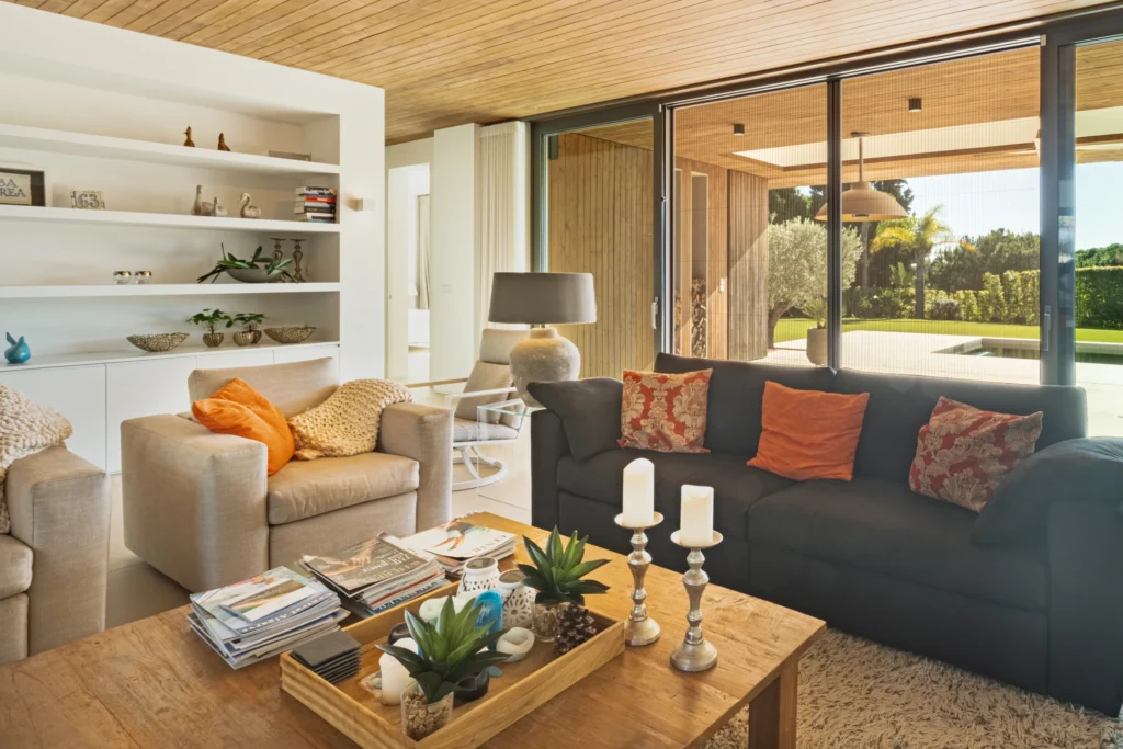 Cozy living room with sliding patio doors, featuring mosquito screens that offer stylish and practical insect protection.