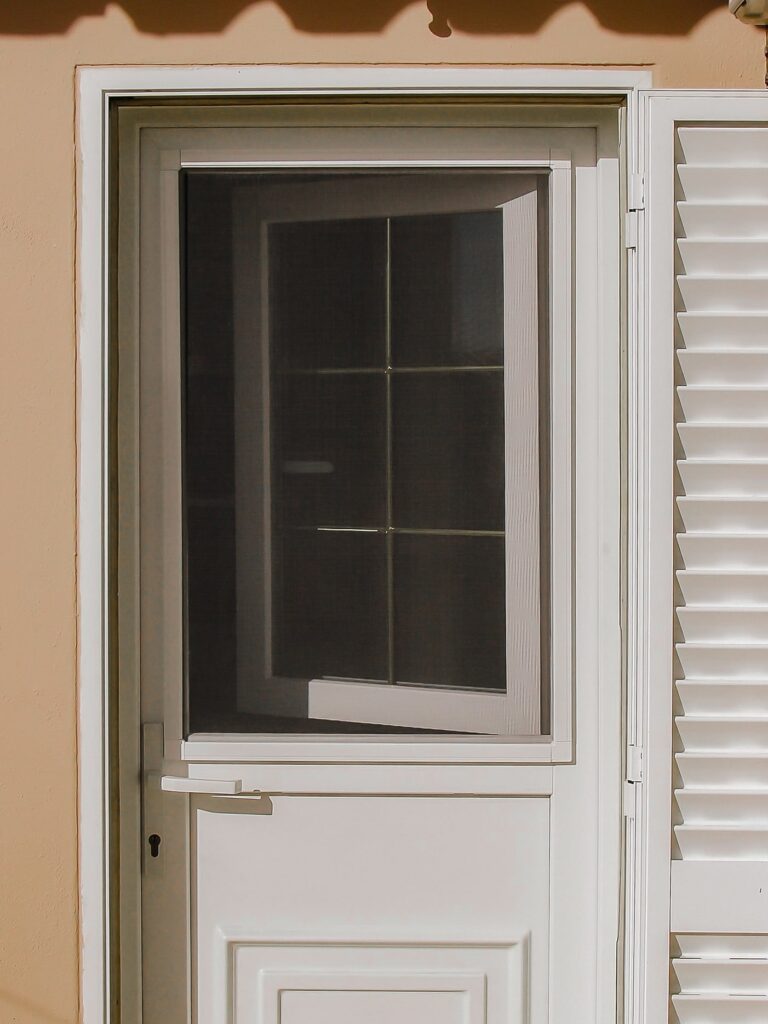 Pratika fixed mosquito screens placed on a traditional Algarve-style vertical window of the outside door