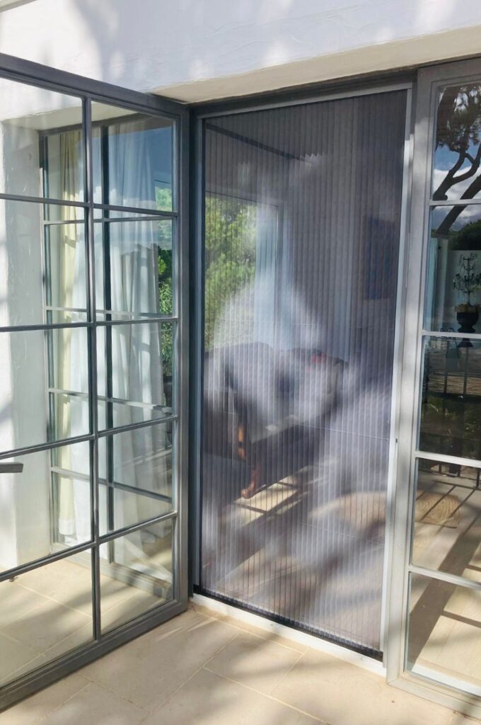 libera grey mosquito screens algarve Retractable Libera mosquito screens on living room tall window, with grey frames.